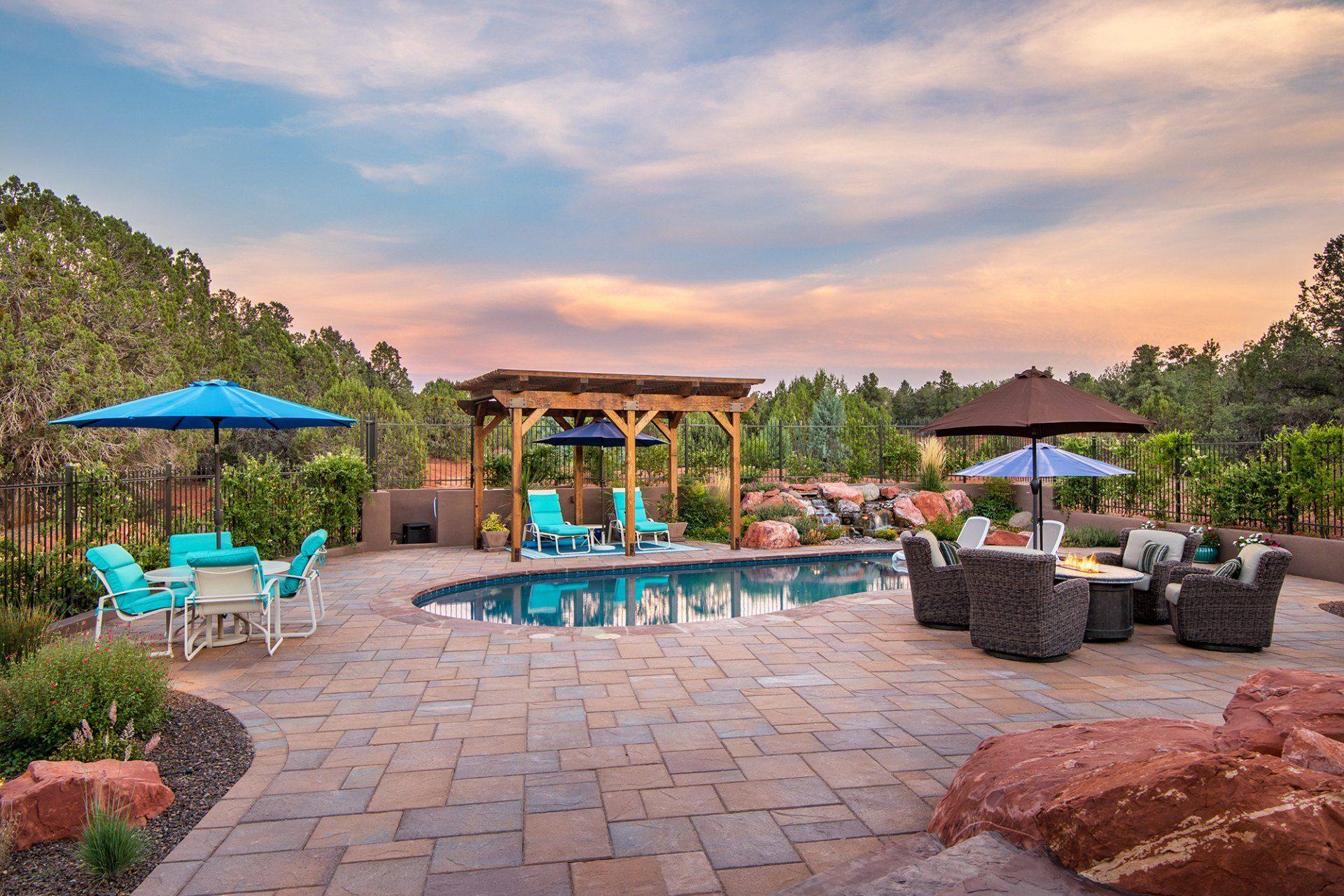 Pool, pergola and paver deck at sunset