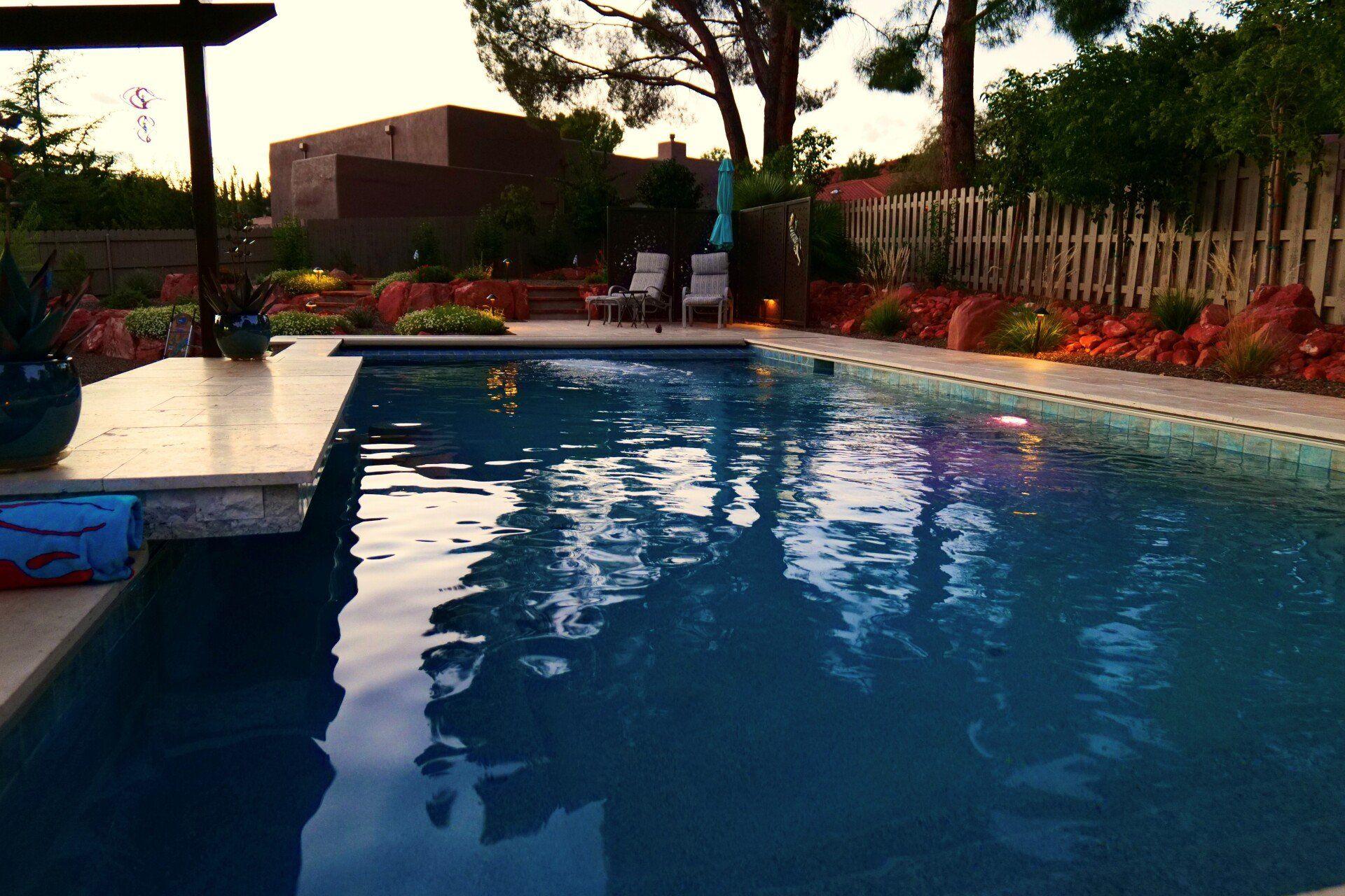 Pool at dusk against the red rocks