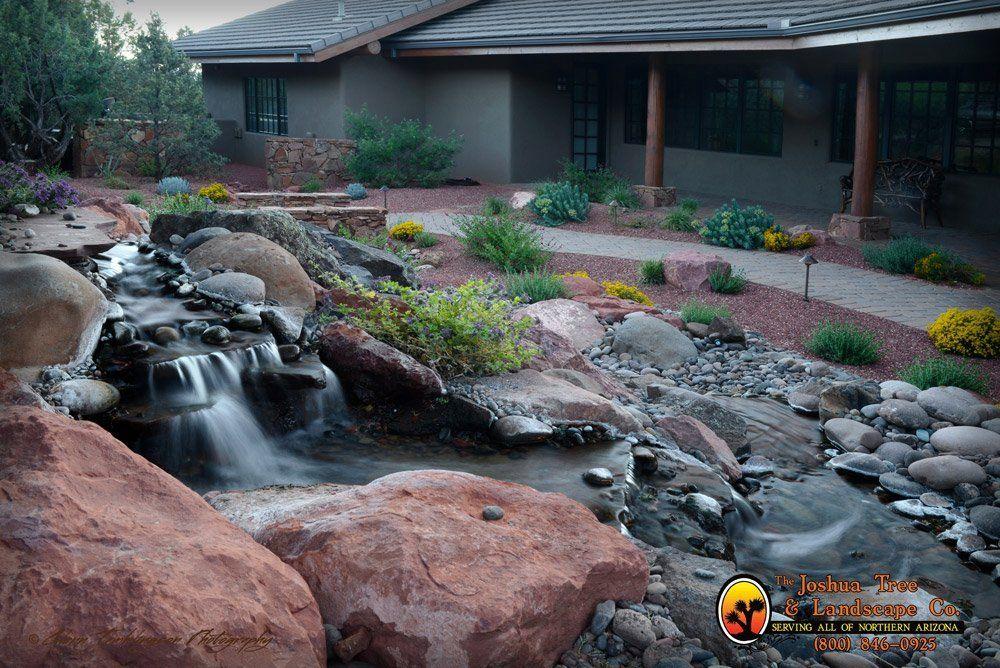 A house with a waterfall in front of it
